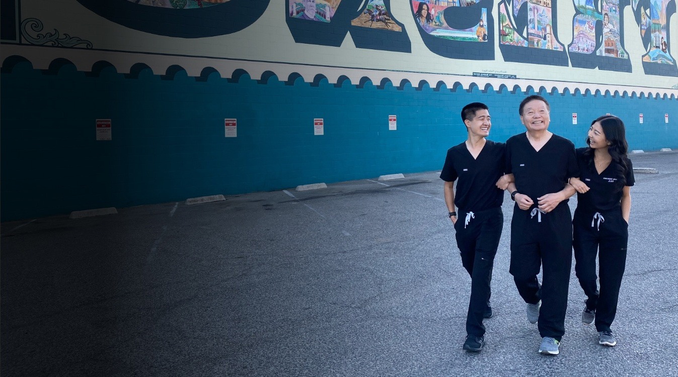 The Fresno California dentists of Shinkawa Dental smiling while walking through parking lot