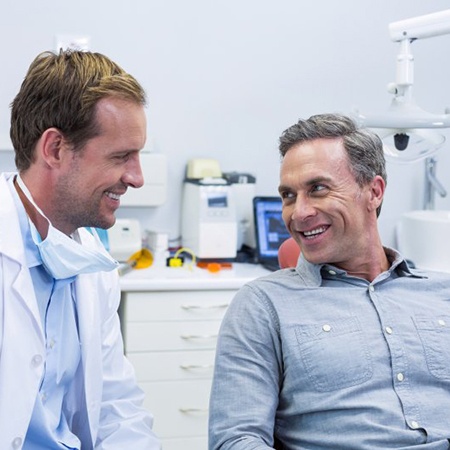 dentist and patient discussing types of dental bridges in Fresno 