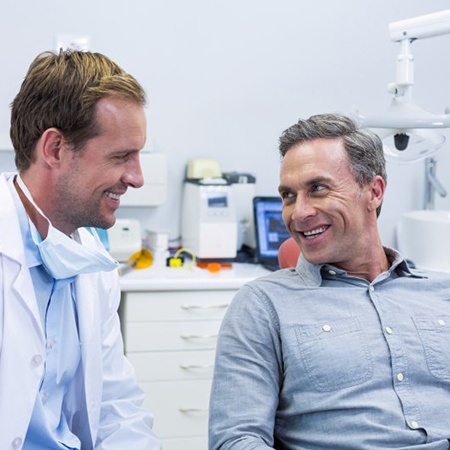 dentist and patient discussing types of dental bridges in Fresno