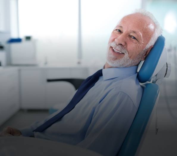 Senior man smiling in dental chair