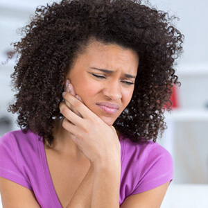 young woman with tooth pain