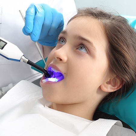 Child receiving dental sealants