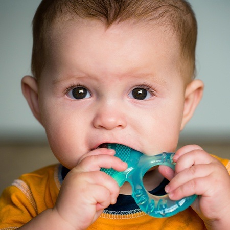 Baby using teething toy