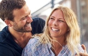 Man and woman laughing together outdoors