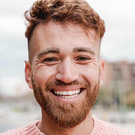 man smiling after getting dental crowns in Fresno