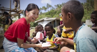 Doctor Shinkawa working with young patients on mission trip