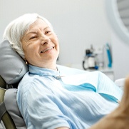 Patient viewing their smile after visiting emergency dentist in Fresno
