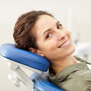 Woman smiling about the cost of emergency dentist in Fresno