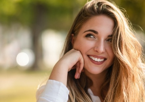 Smiling woman looking off into distance outdoors