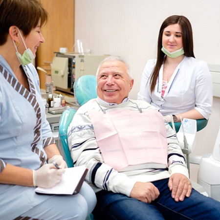 Man learning benefits of dental implants in Fresno with dentists