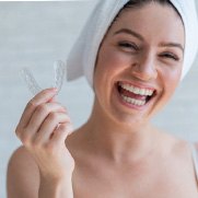 Woman holding a mouthguard in Fresno 