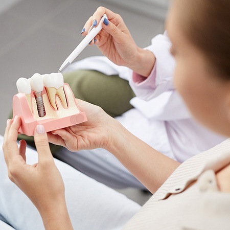 A dentist telling a patient about the cost of dental implants in Fresno