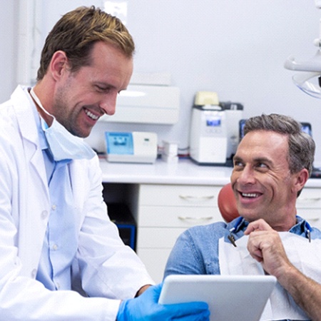 Man smiling at dentist in Fresno