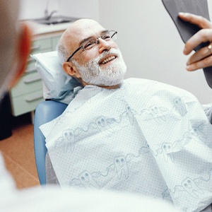 Man smiling after getting dental implants in Fresno