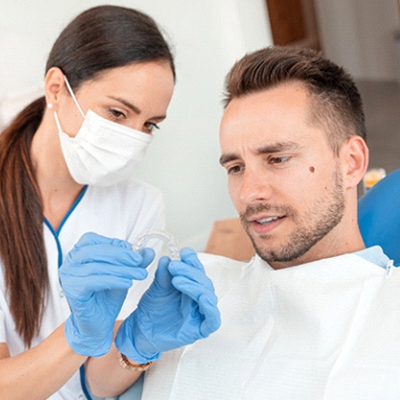 Cosmetic dentist in Fresno discussing Invisalign with patient