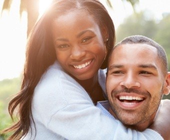 Man and woman with healthy smile after preventive dentistry