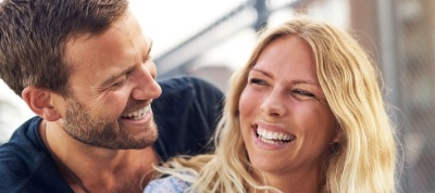 Man and woman laughing together outdoors