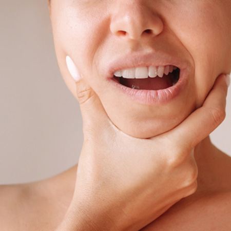 Woman holding her jaw