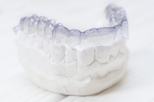 Bottom Invisalign aligner on dental mold