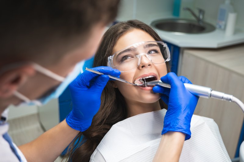 A woman receiving a root canal