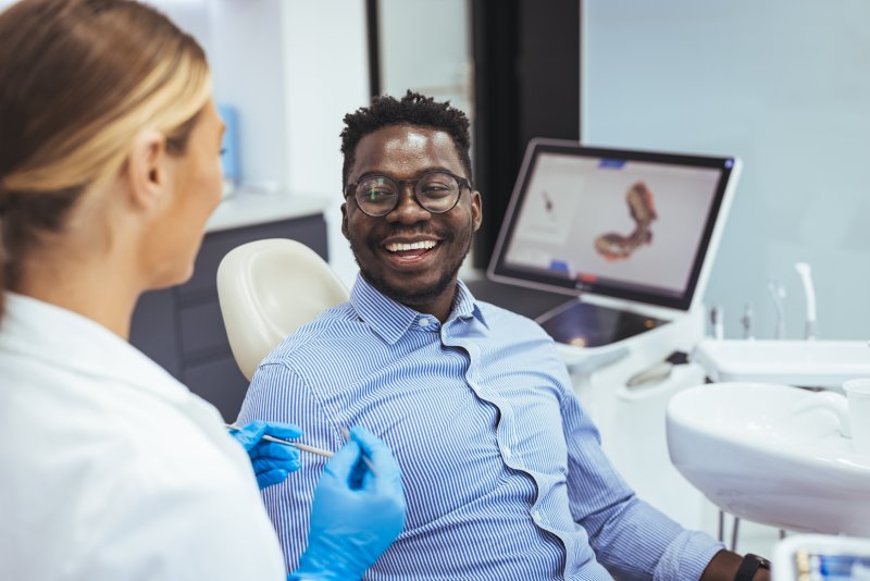 Patient smiling as they recover from their root canal